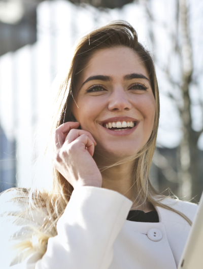 lady smiling while touching the side of her face