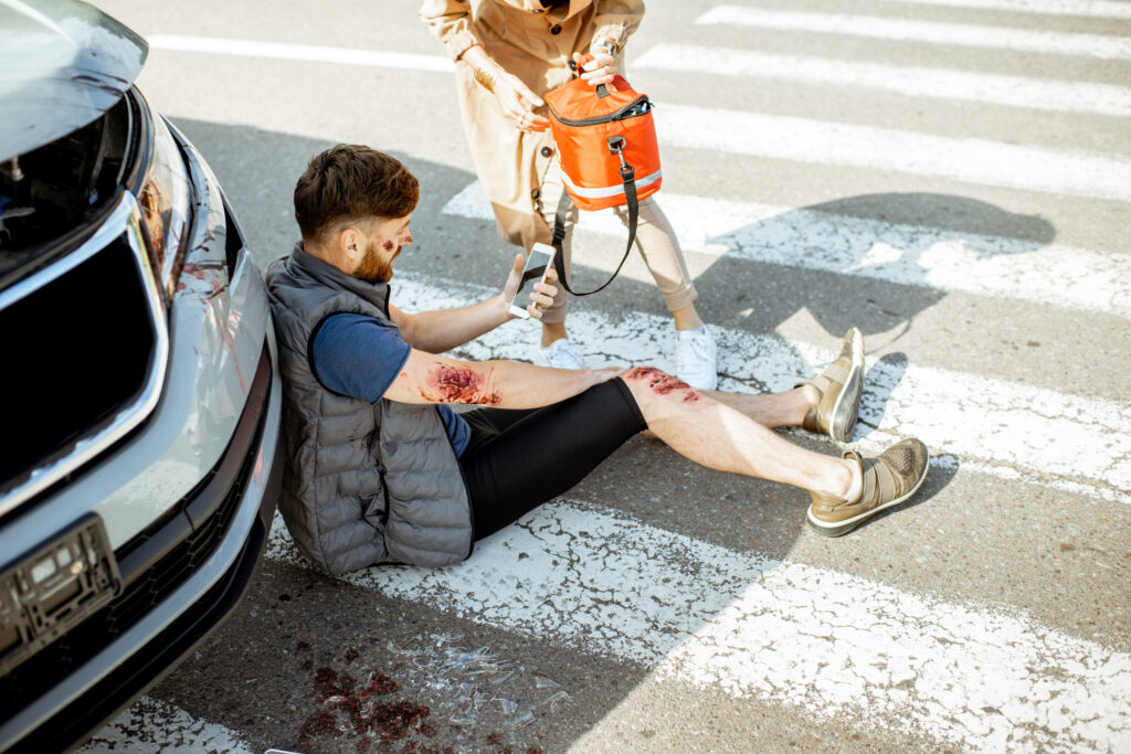 Woman driver with injured man on the road