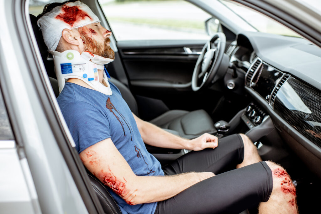 Injured man in the car after the road accident